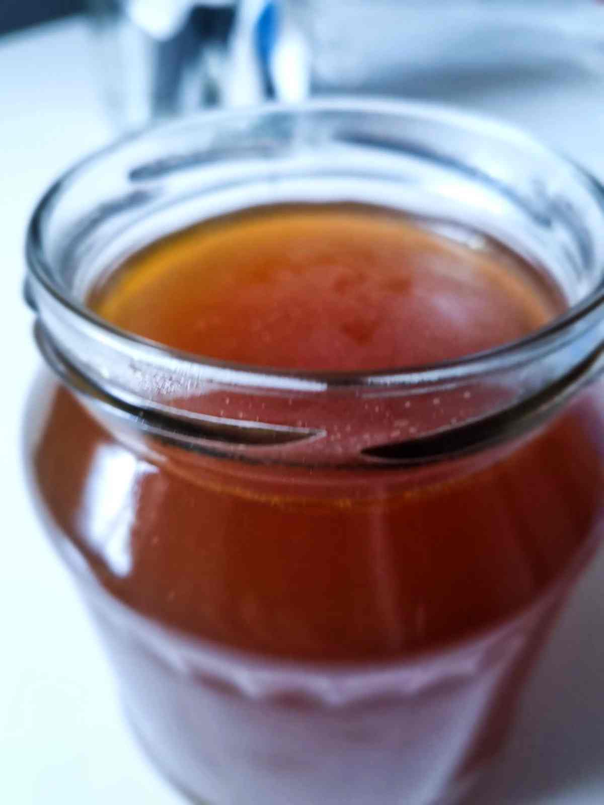 Brown Chicken Broth in a Glass Jar