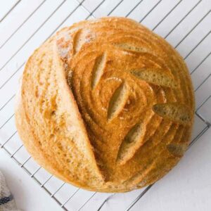 Gluten-free vegan sourdough bread on a cooling rack.