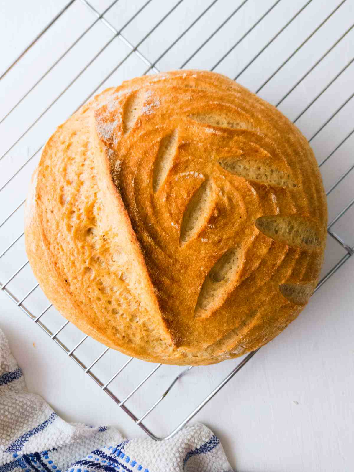 Gluten-free sourdough bread on a cooling rack.