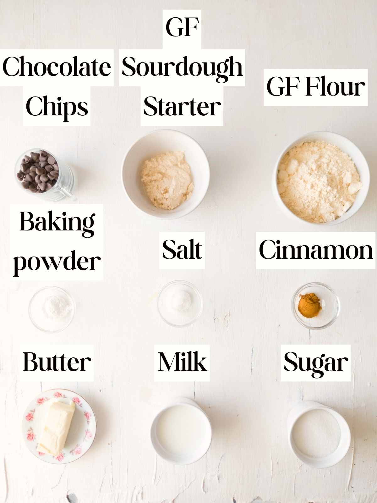 Ingredients for the scones on a white surface in little bowls.