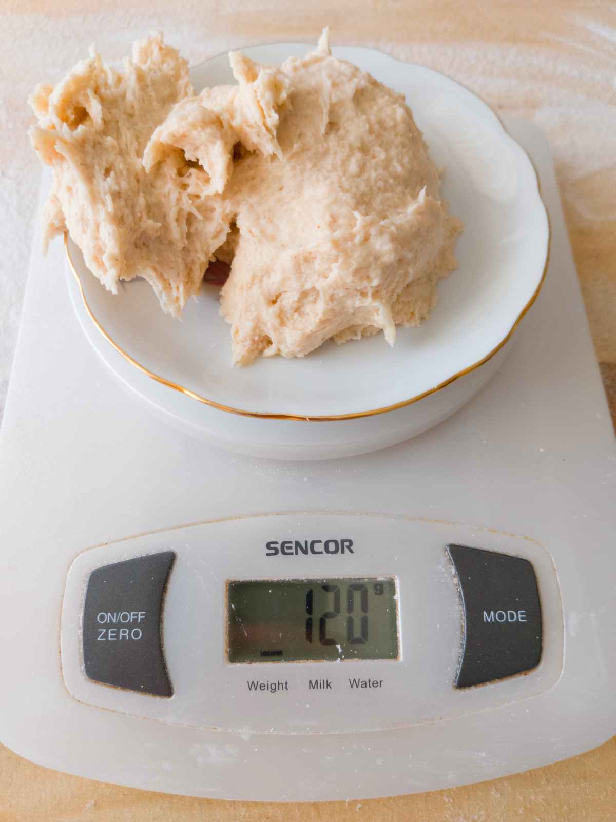 Using a digital scale to measure out pretzel pieces.