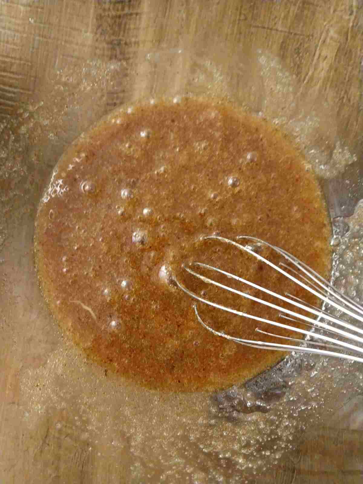 Mixing eggs with the sugar mixture.