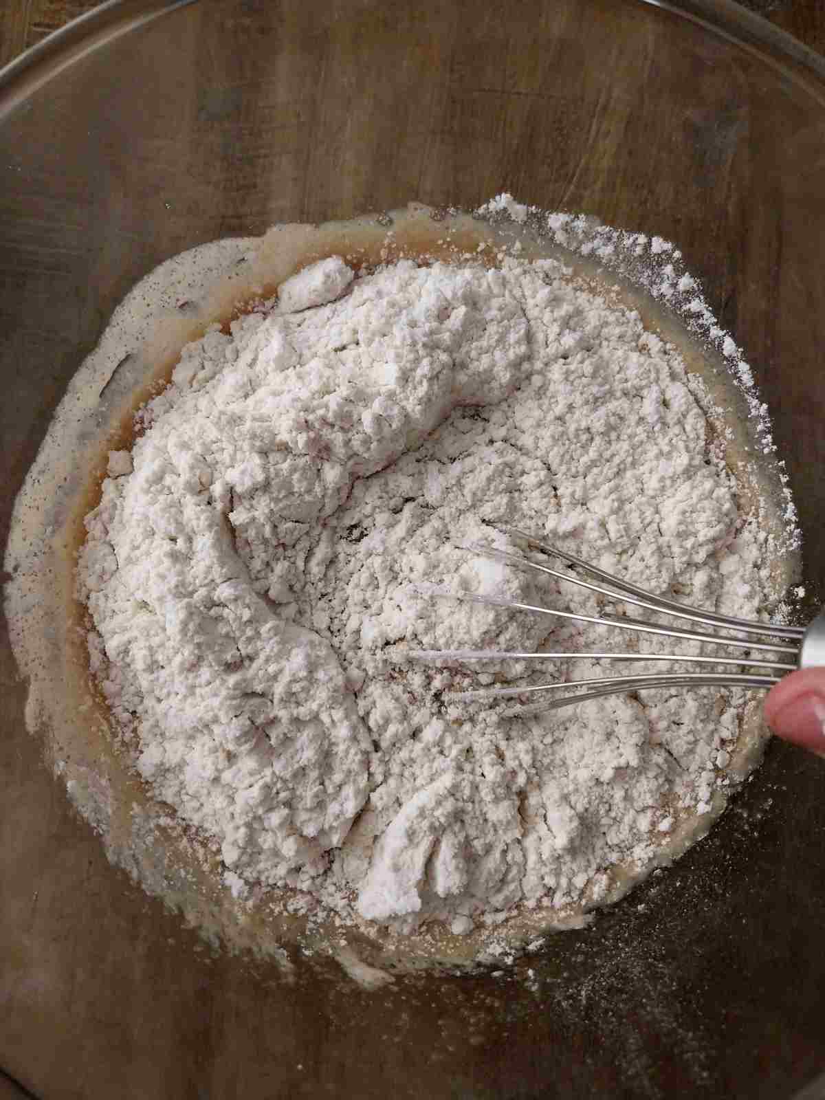 Mixing the flour into the dough.