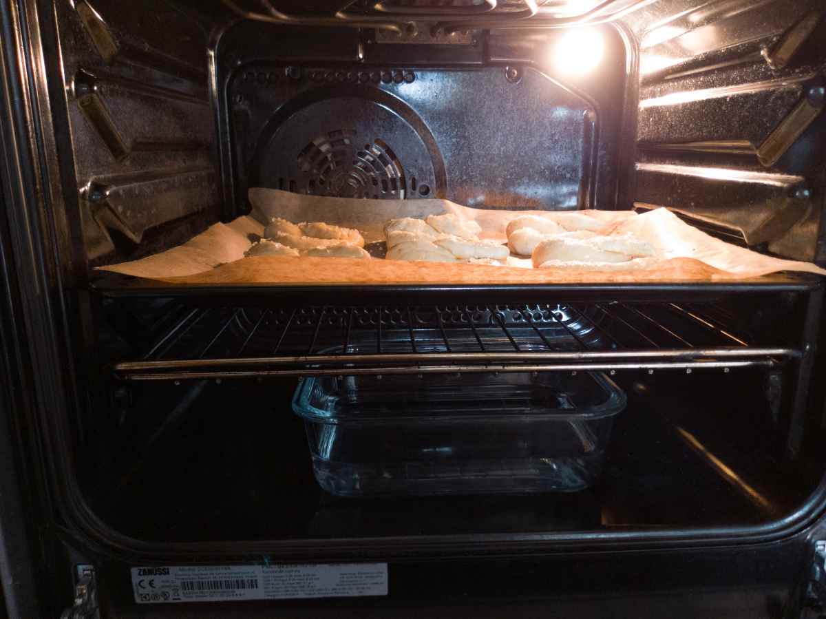 Oven set up for baking pretzels with water tray at the bottom.
