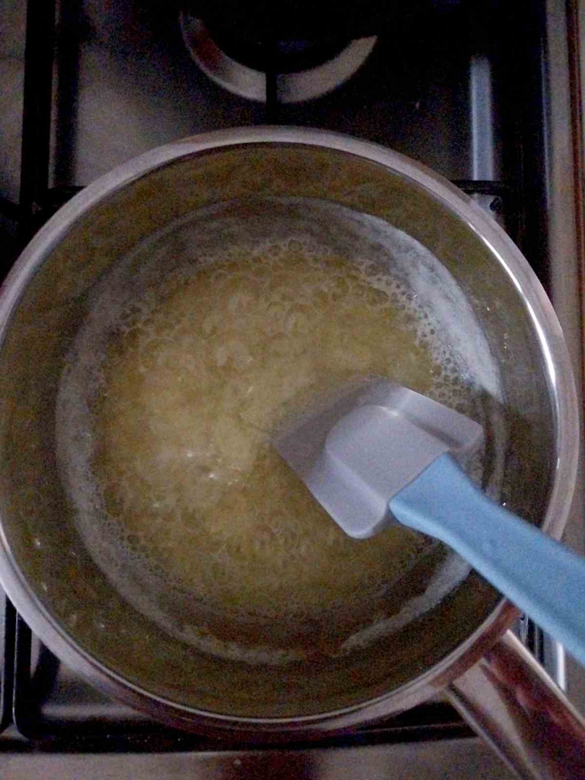 Boiling butter with a spatula inside.