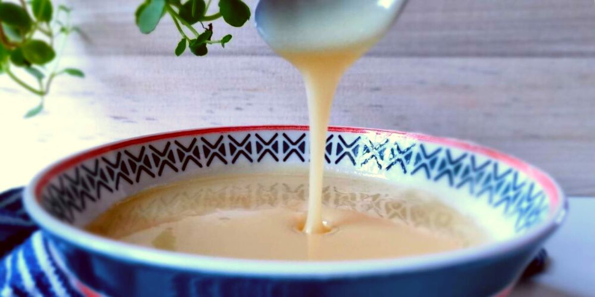Condensed Milk dripping from a spoon.