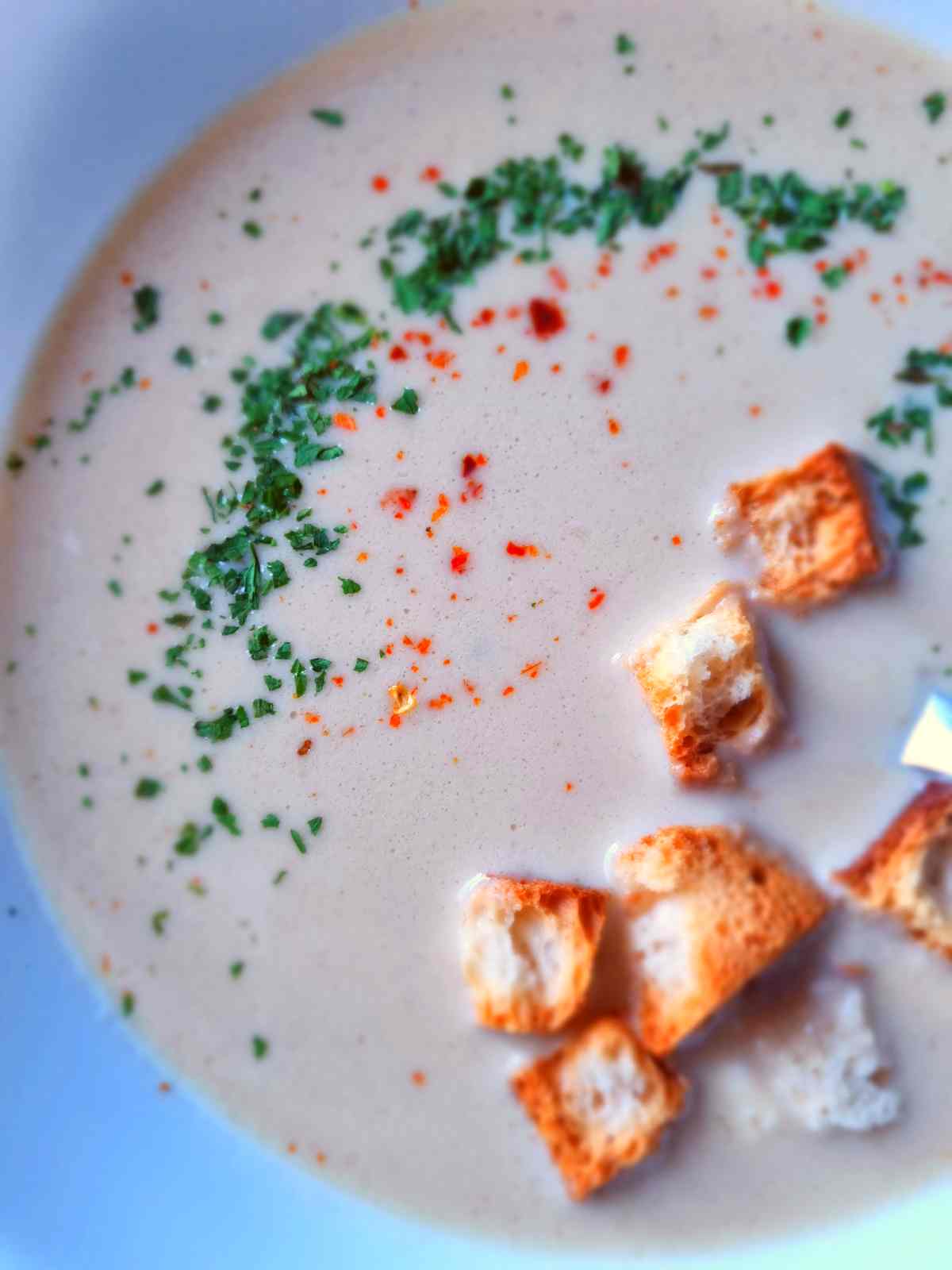 Hungarian garlic soup with croutons up close.