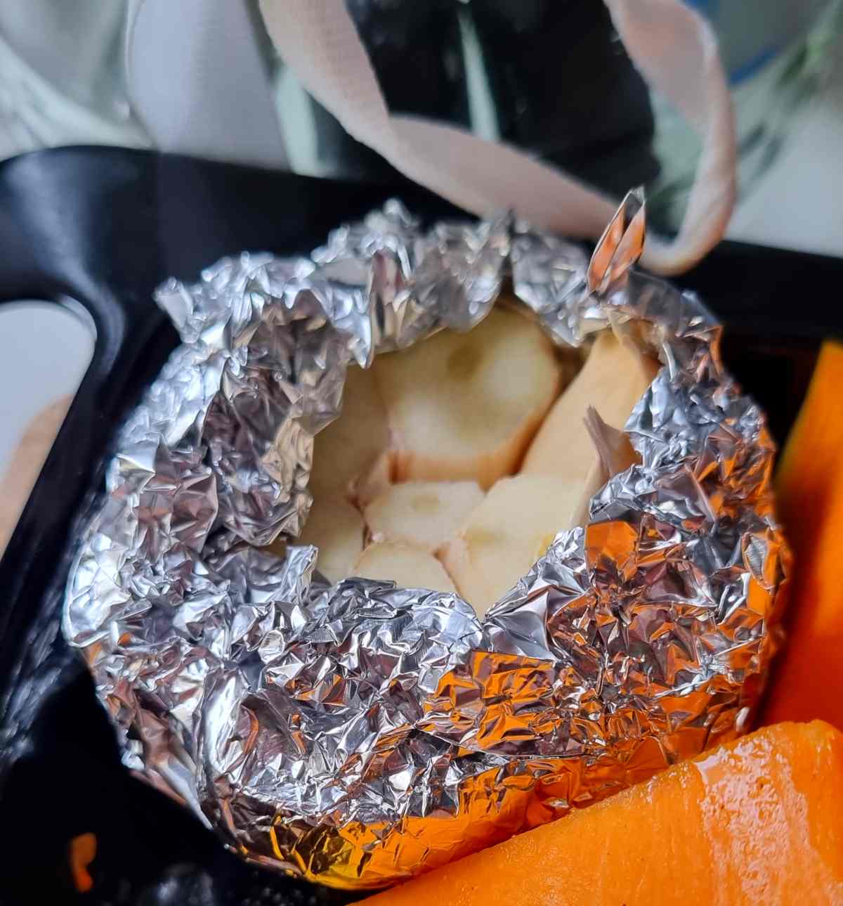 A head of garlic wrapped in foil.