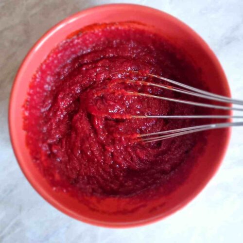 Ketchup substitute in a red boal with a whisk.
