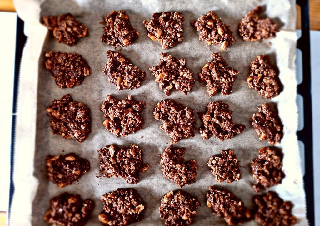 Cookies on a piece of parchment on a baking sheet.