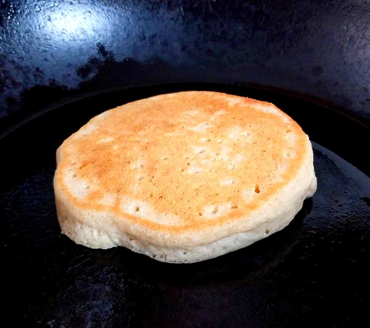 Fried pancake in a cast iron pan.