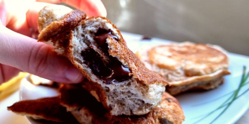 A chocolate filled pancake with melted chocolate inside.