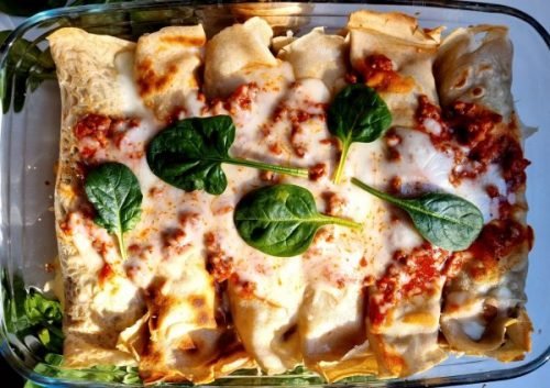 Gluten-Free Savory Crepes with mushrooms and ricotta in a glass dish.