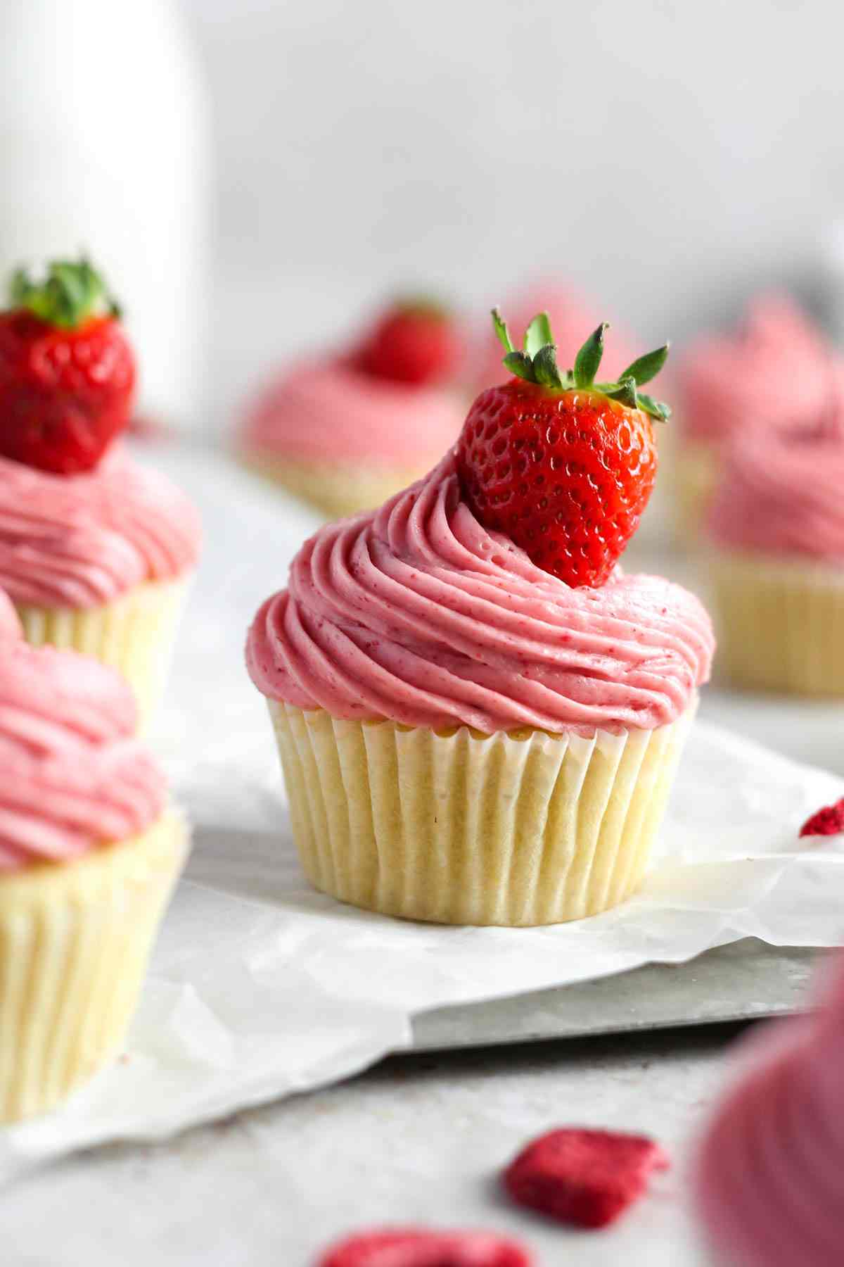 Strawberry cupcakes on a white table.