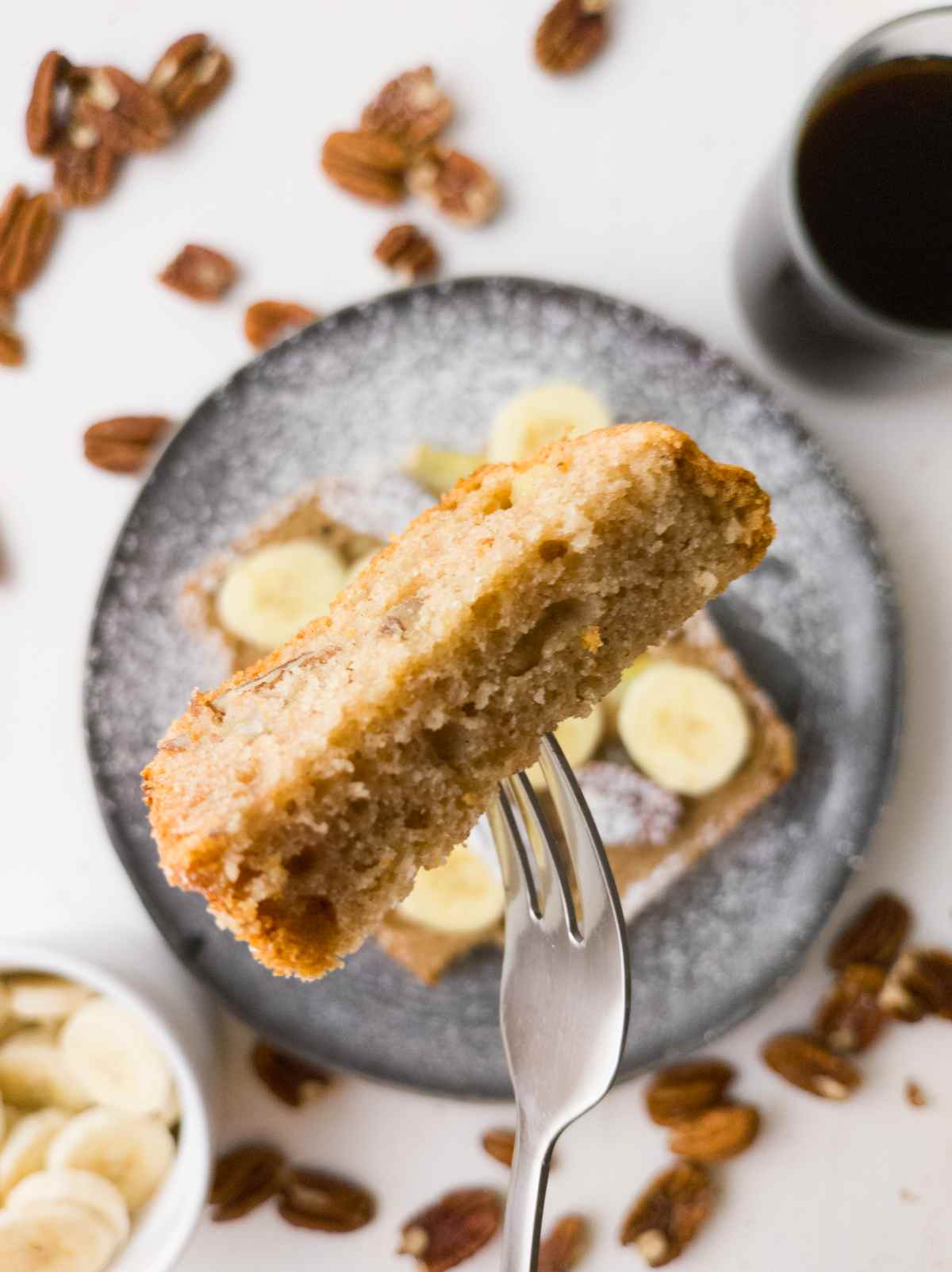 A slice of the banana bread up close on a fork.