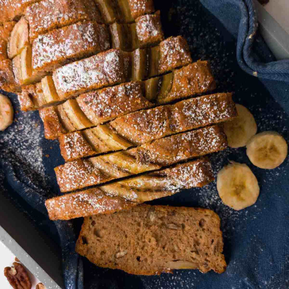 Gluten-free sourdough banana bread sliced on a blue towel.