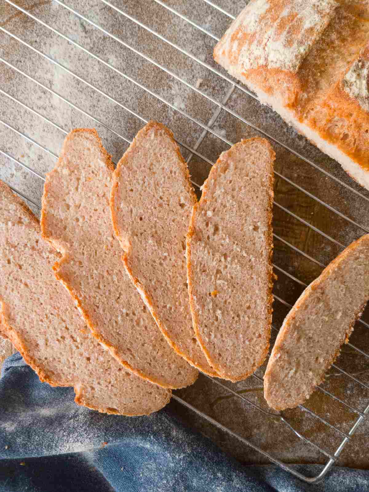 Gluten-free bread with psyllium husk sliced on a cooling rack.