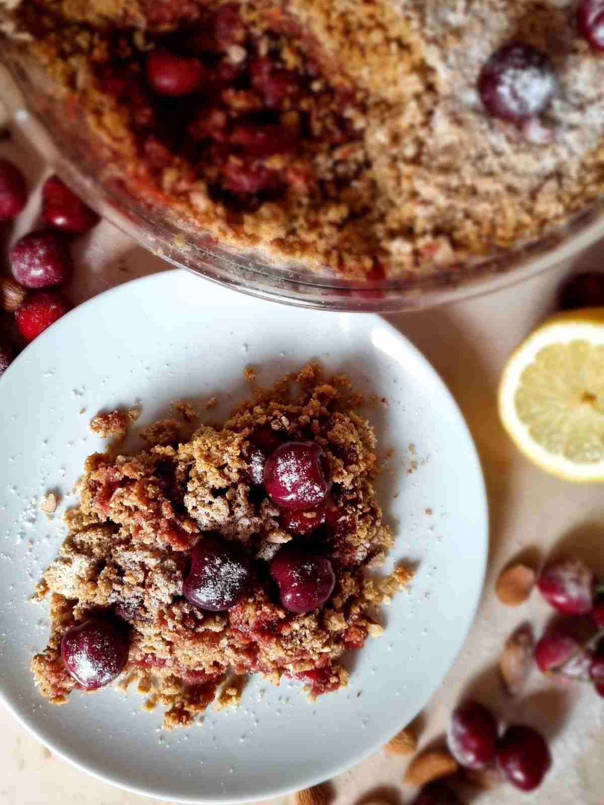 Gluten-free cherry crisp portion on a plate from above.