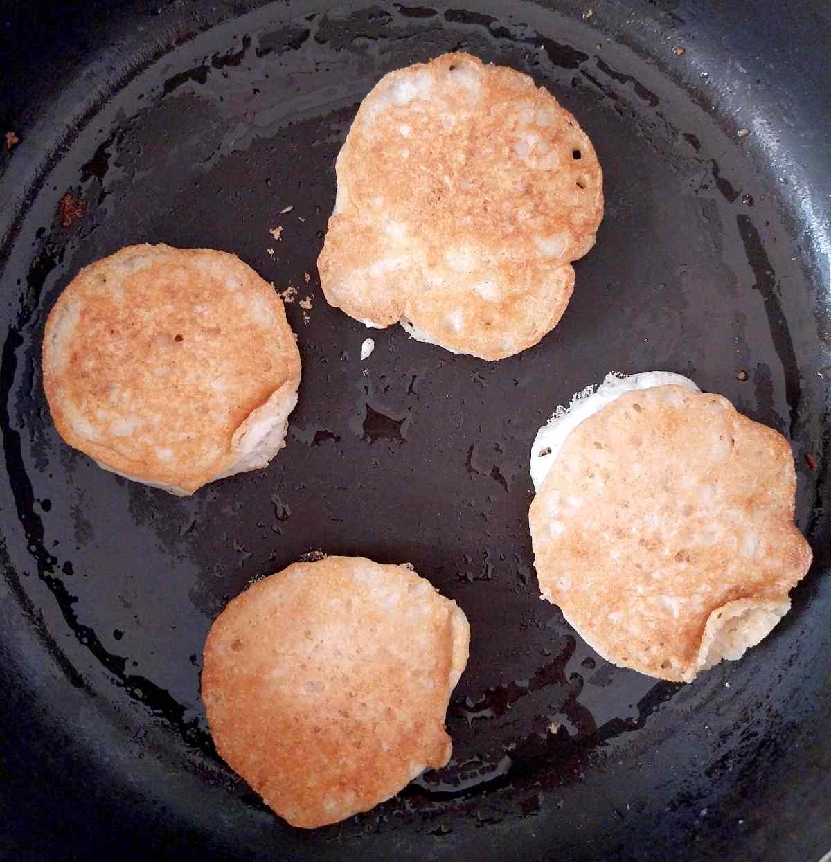 Frying the crumpets on the other side.