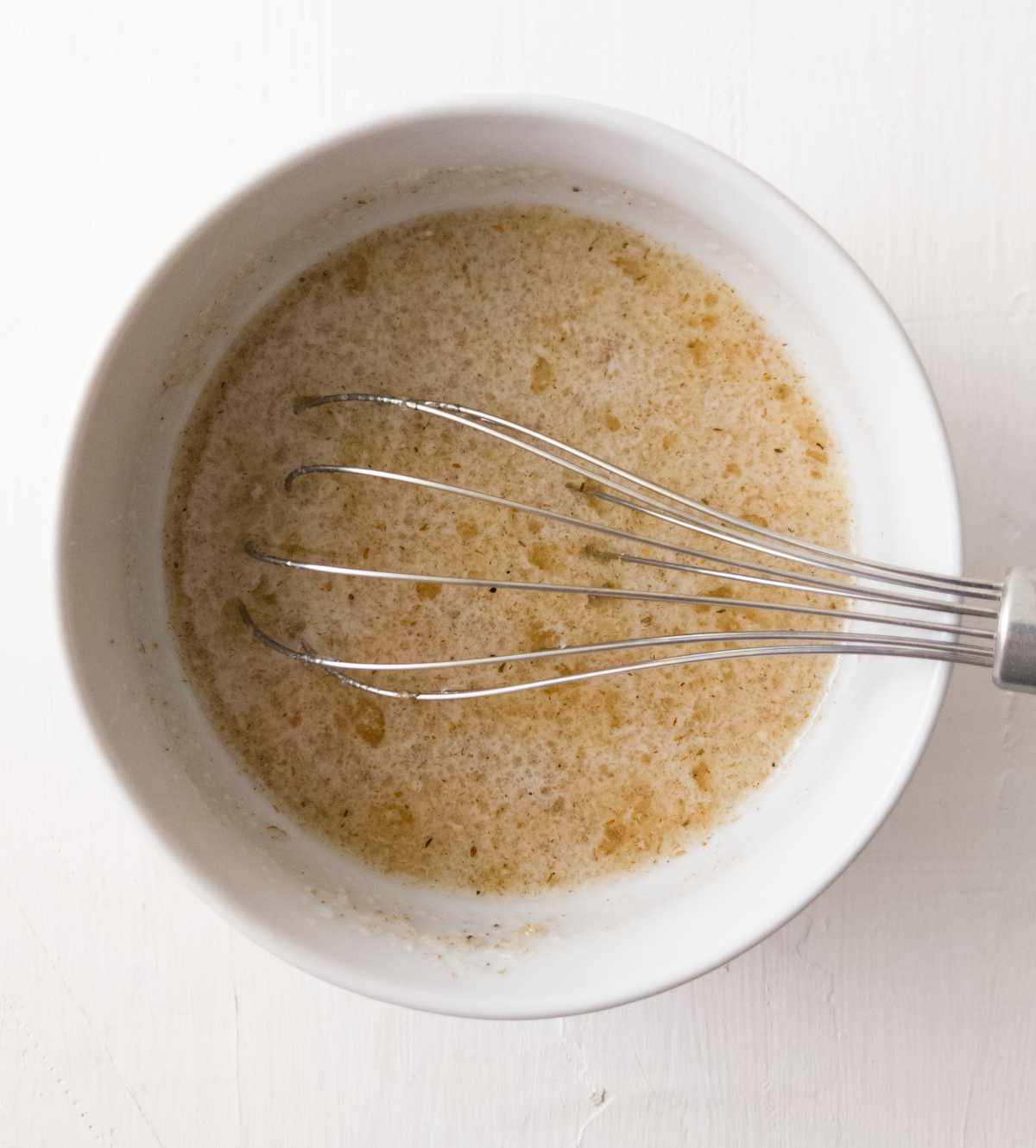 Psyllium husk mixture in a bowl with a whisk.
