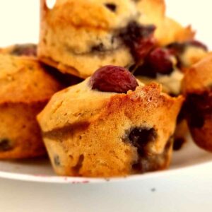 Cherry muffins on a white plate.