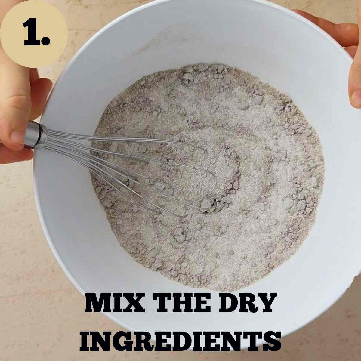 A mixing bowl with a whisk and dry ingredients inside.