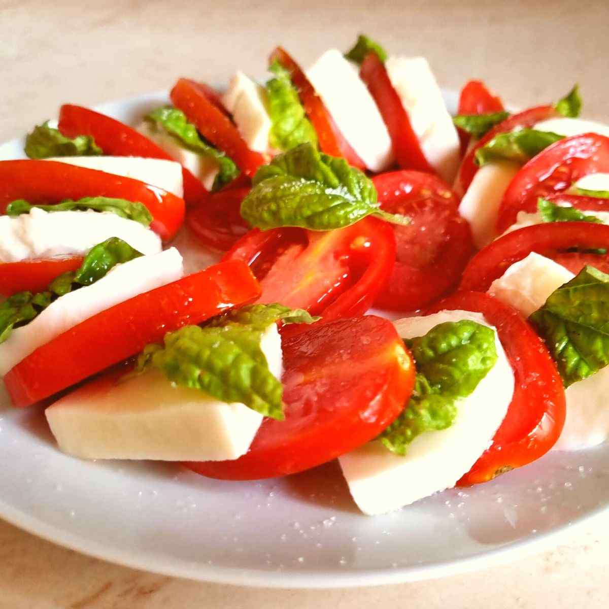 Caprese salad on a white plate.