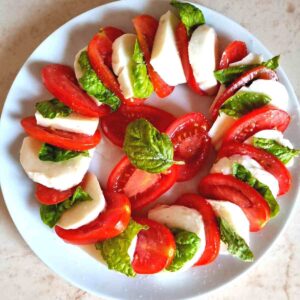 Cherry tomato caprese salad on a plate.