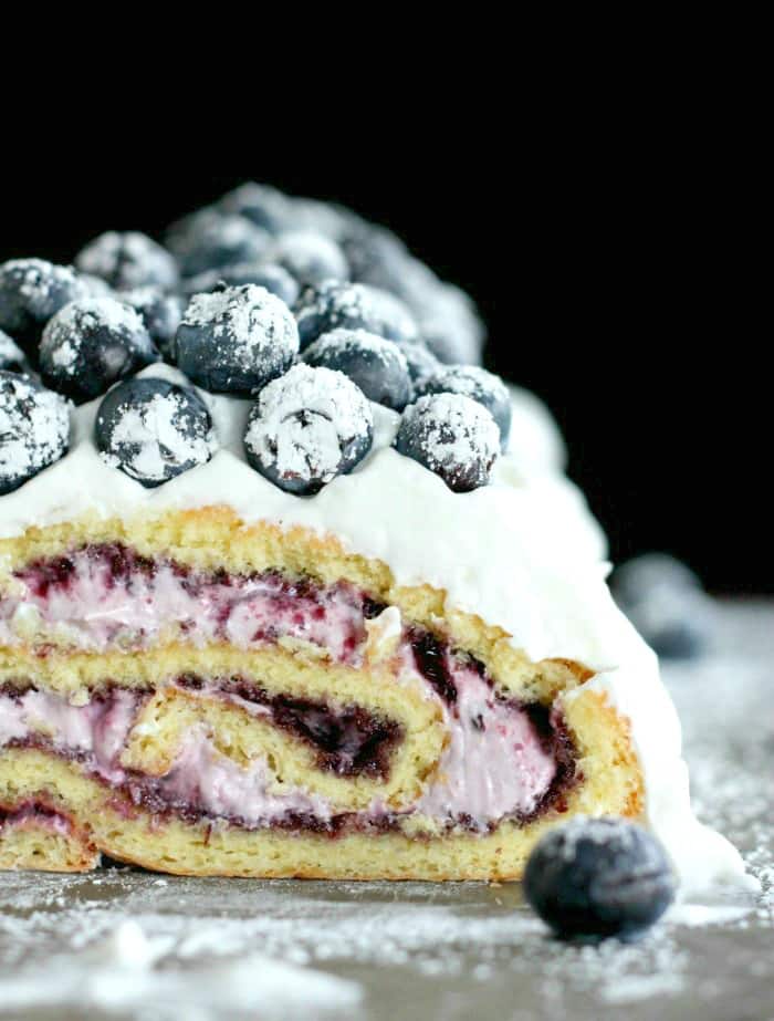 Elderberry blueberry cake roll with blueberries on top. 