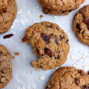 A buckwheat cookie on a parchment paper with other cookies around.