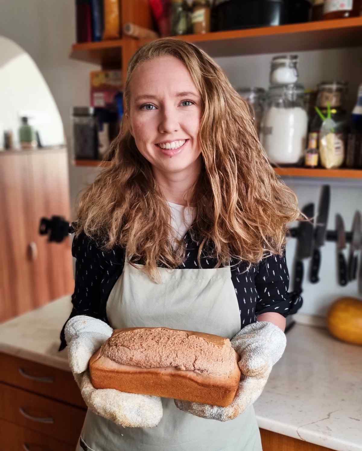 Natasha holding a loaf of bread.