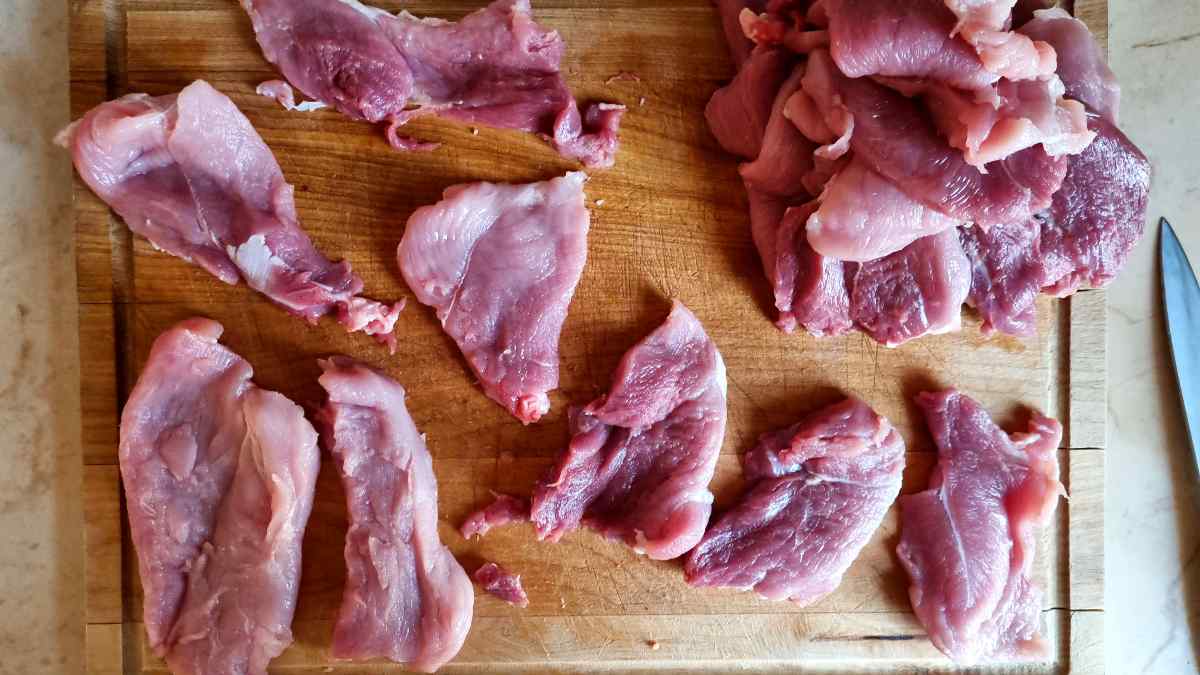 Sliced pork on a cutting board.