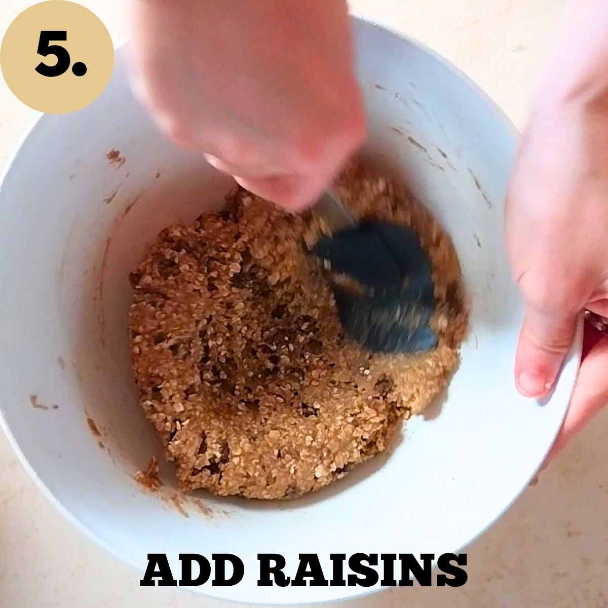 Mixing the dough with a spatula in a large white mixing bowl.