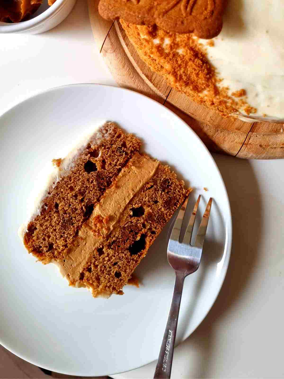 A piece of biscoff birthday cake on a plate.
