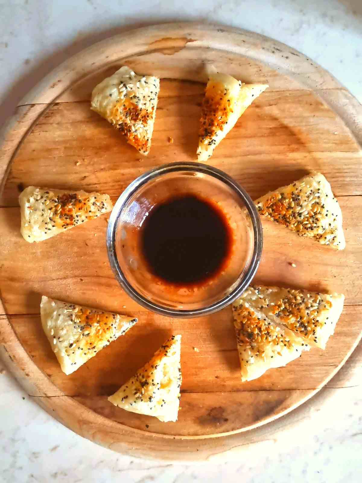 Fried sourdough starter with sesame seeds and poppy seeds and sauce.