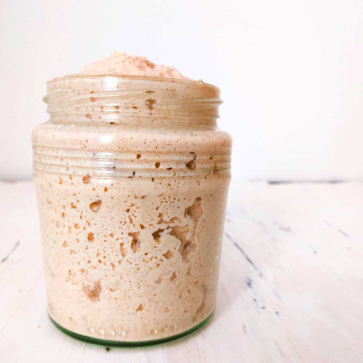 Gluten-free sourdough starter in a jar up close.