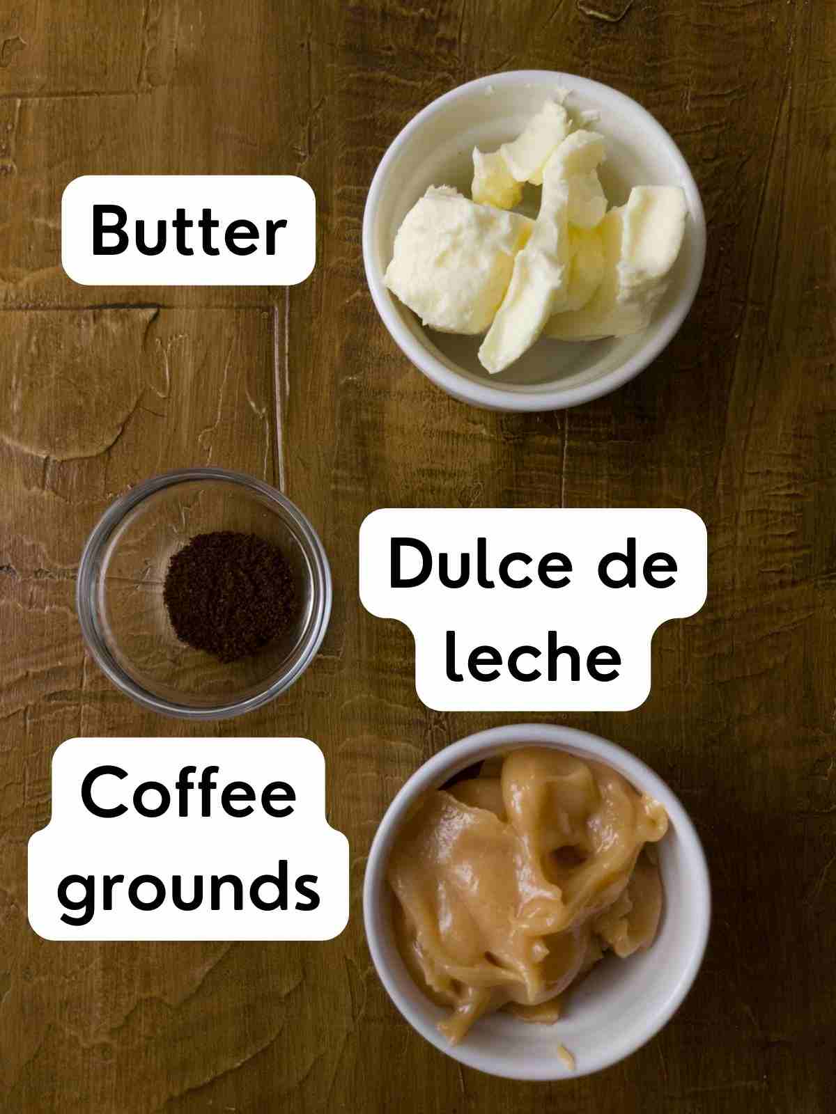 Ingredients for dulce de leche buttercream on a wooden surface.