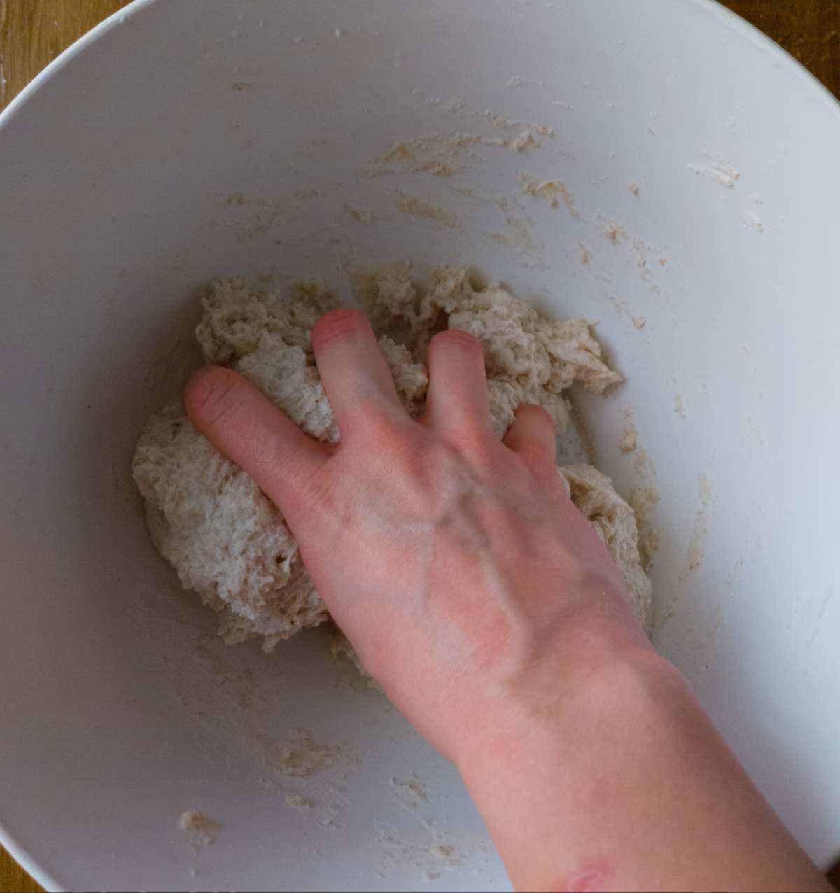 Mixing the dough by hand in the mixing bowl.