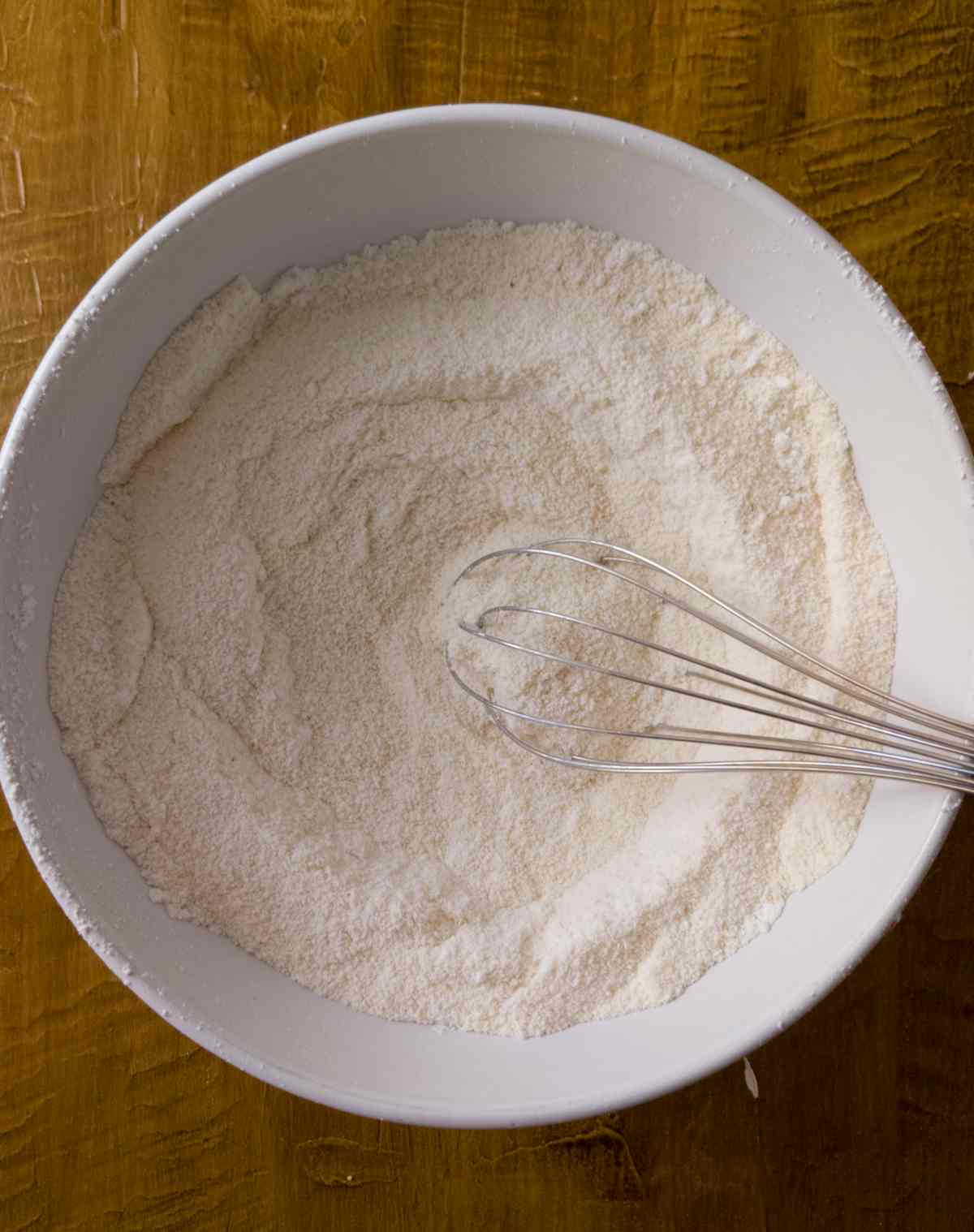 Whisking almond flour with powdered sugar.