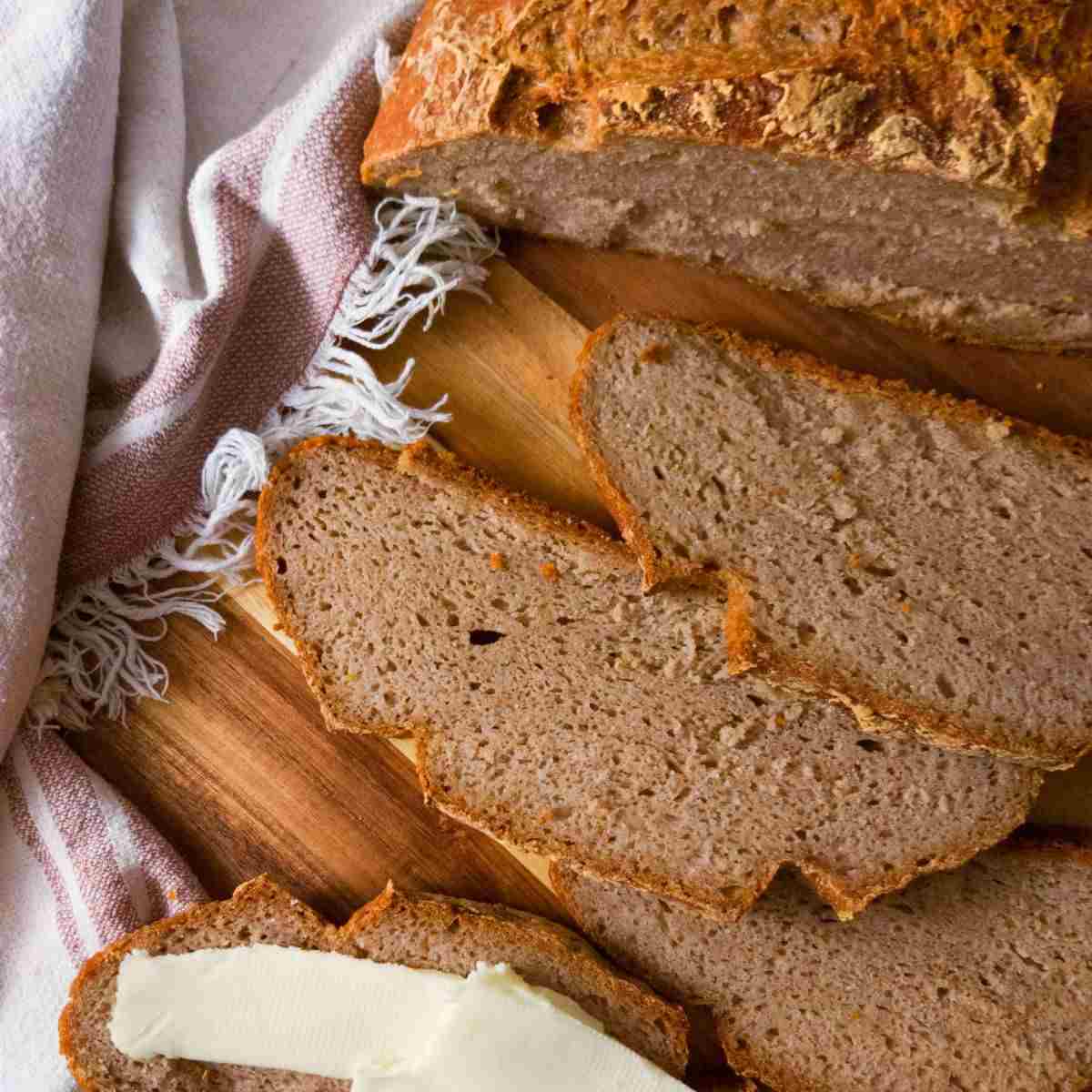 Sliced buckwheat sourdough on a wooden board.