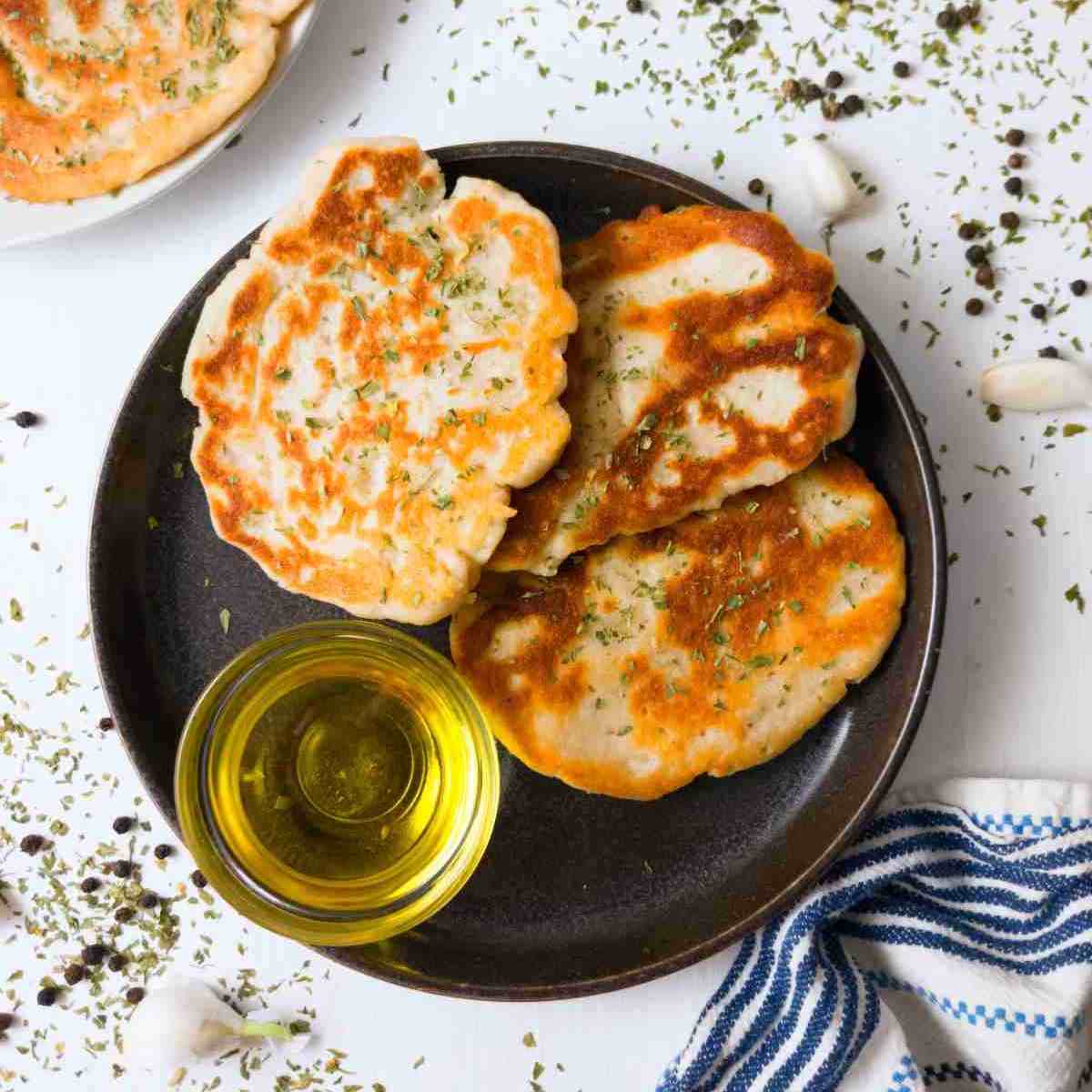 Gluten-free sourdough flatbreads on a plate with oil.
