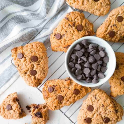 Gluten-free sourdough scones with chocolate chips on a cooling rack.