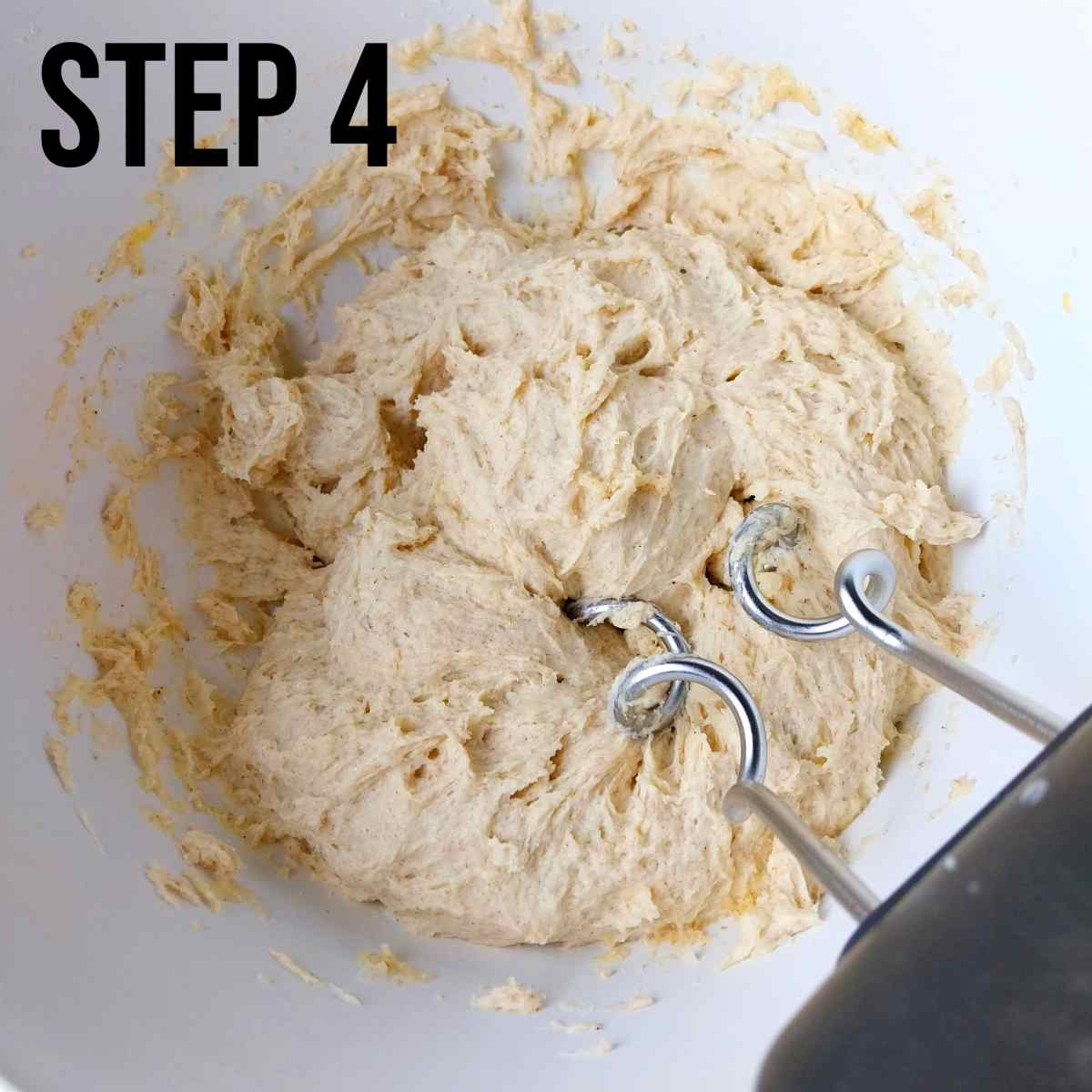 Mixing the dough with an electric mixer.