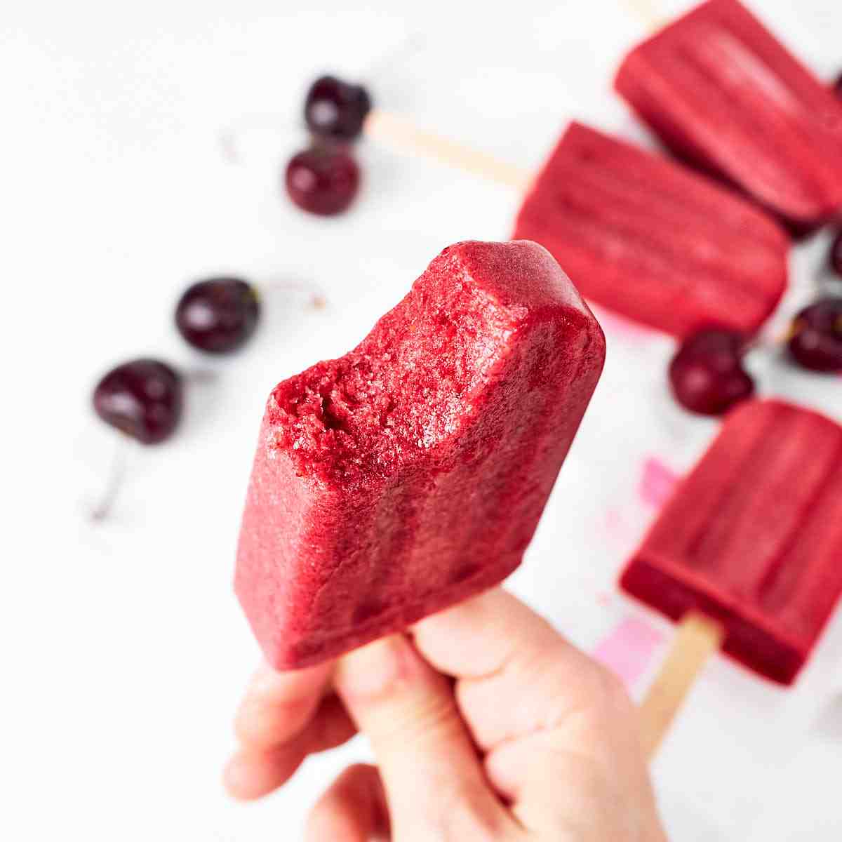 Cherry popsicles on a white background.