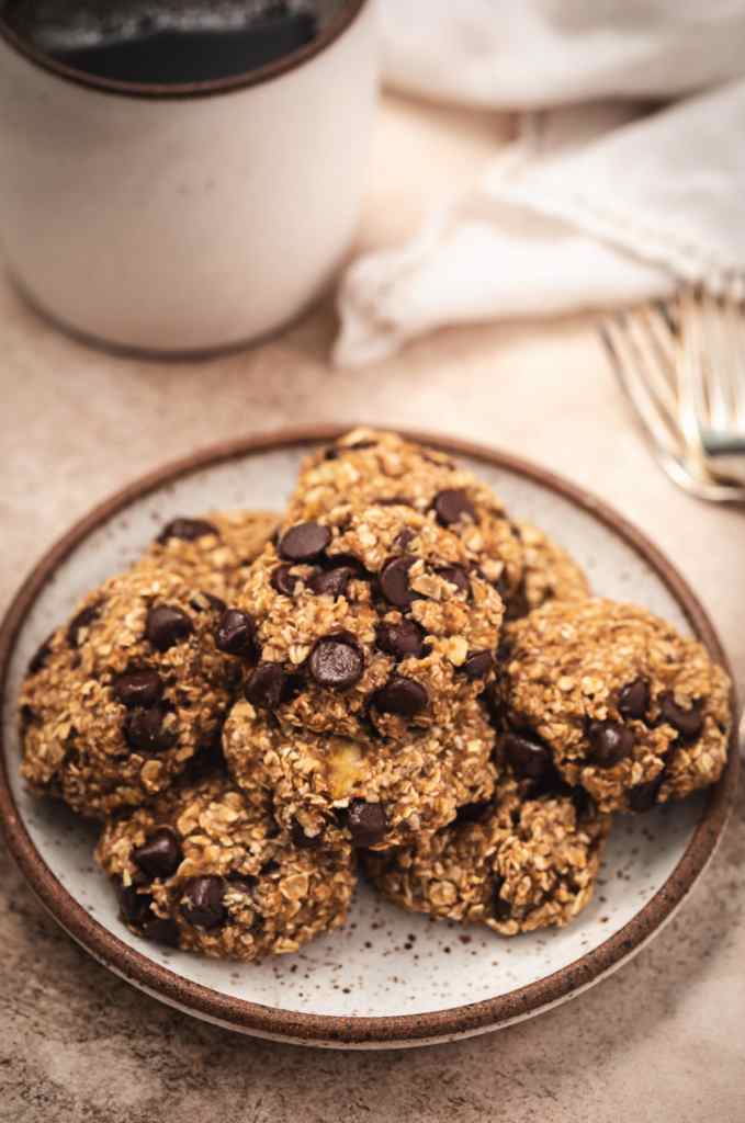 Chocolate chip banana oatmeal cookies on a plate on a table.