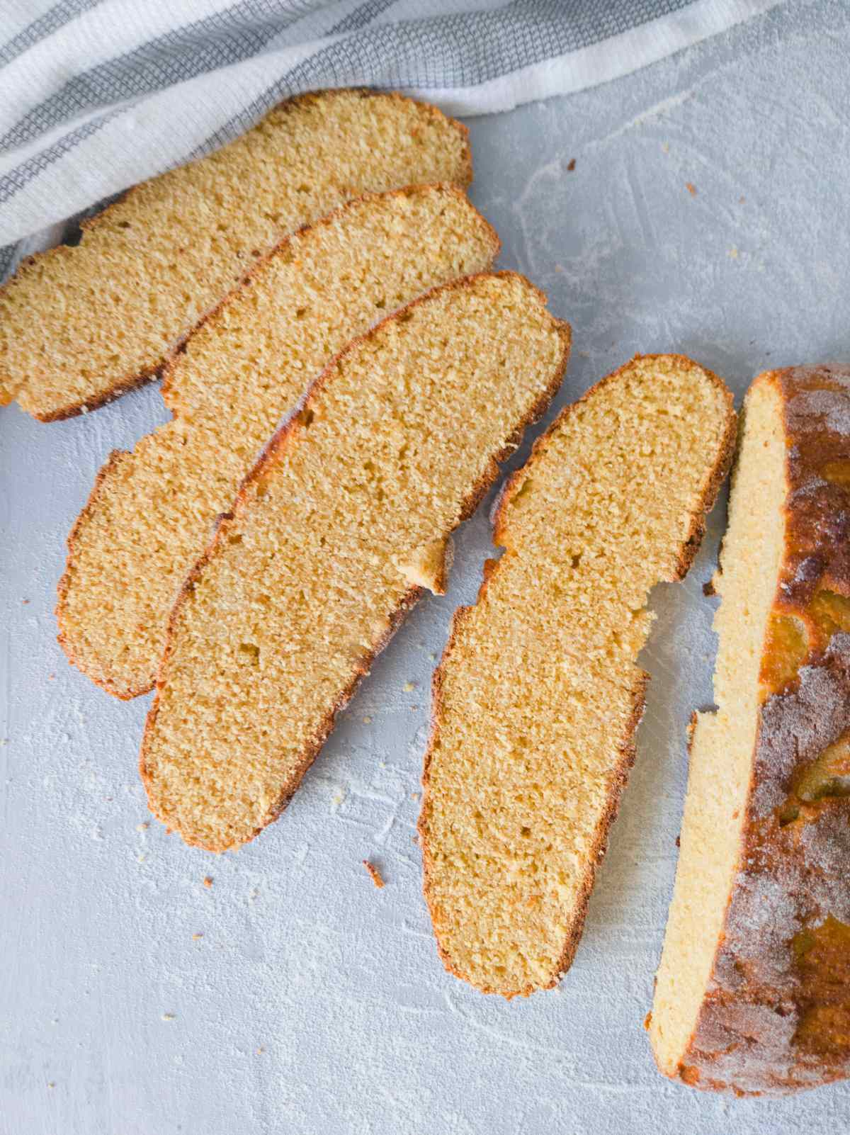 Gluten-free chickpea bread sliced on a light surface.