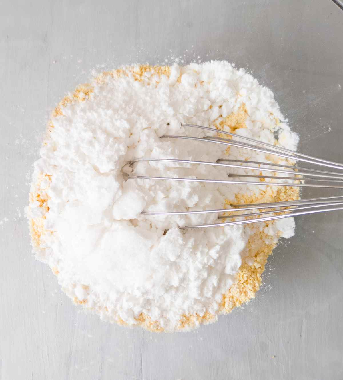 Mixing dry ingredients in a large mixing bowl with a whisk. 