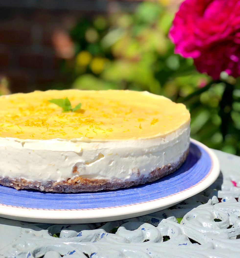 Lemon curd cheesecake on a blue plate.