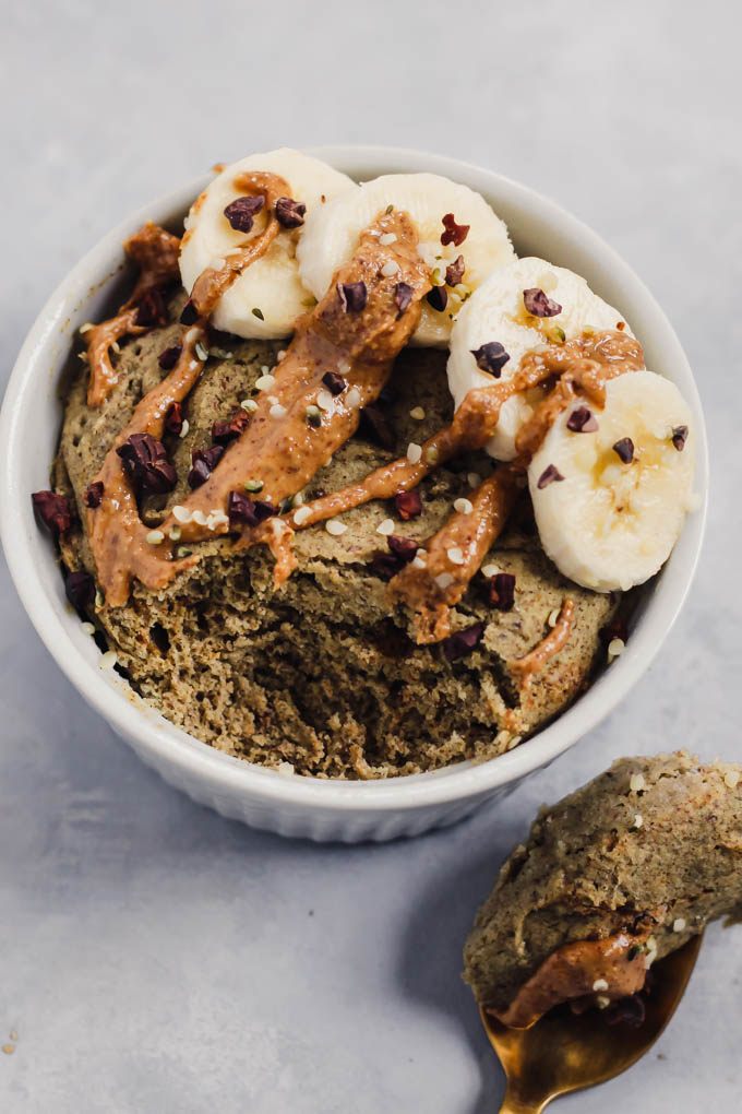 Buckwheat breakfast mug cake on a white surface.