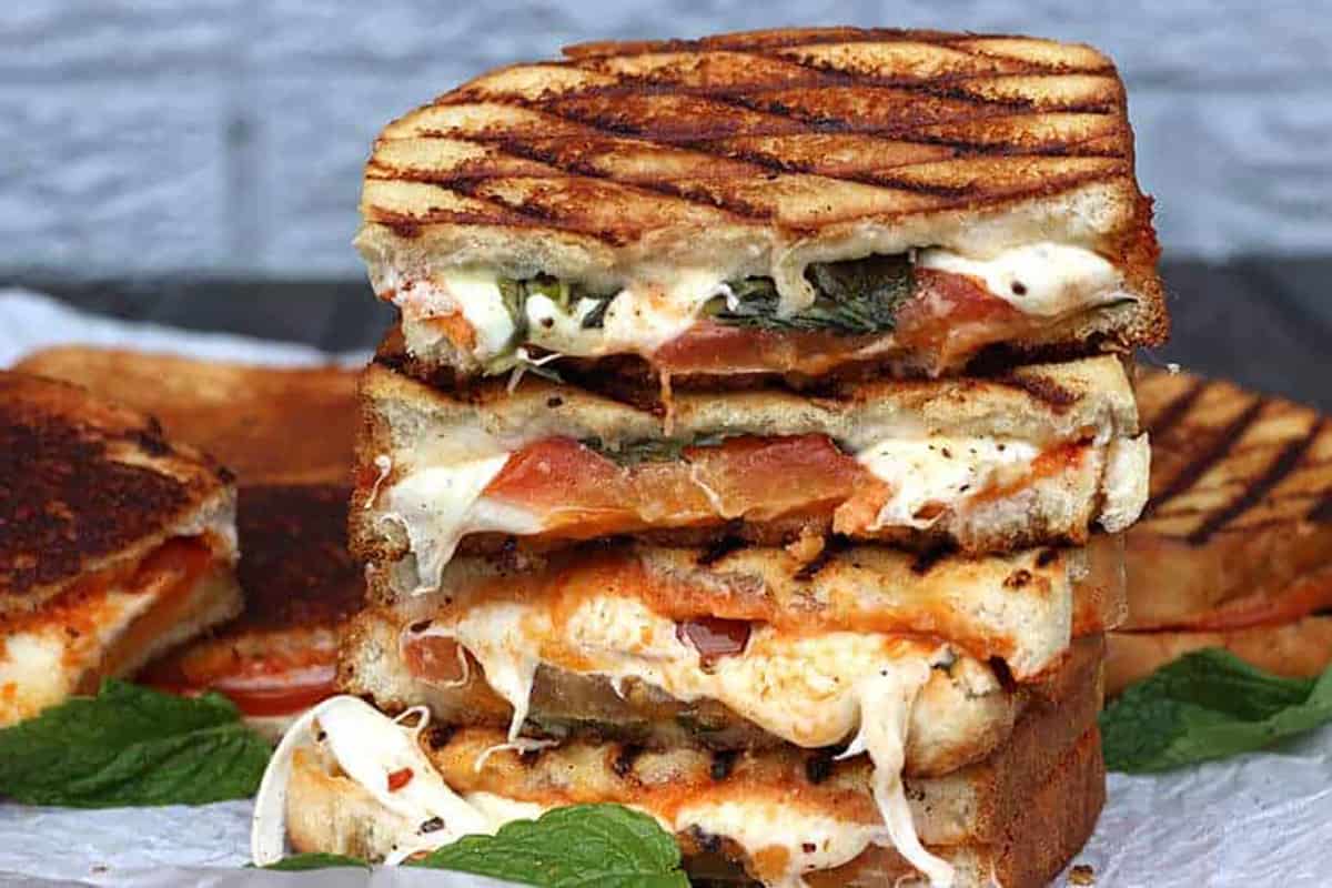 Grilled Margherita Sandwich in a stack on a table.